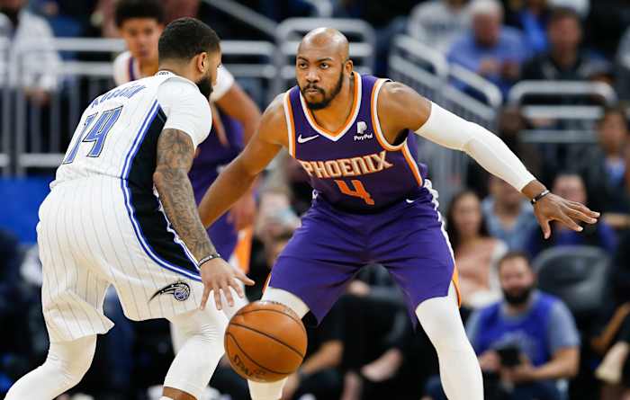 Phoenix Suns guard Jevon Carter (4) guards Orlando Magic guard D.J. Augustin (14) during the second half at Amway Center.